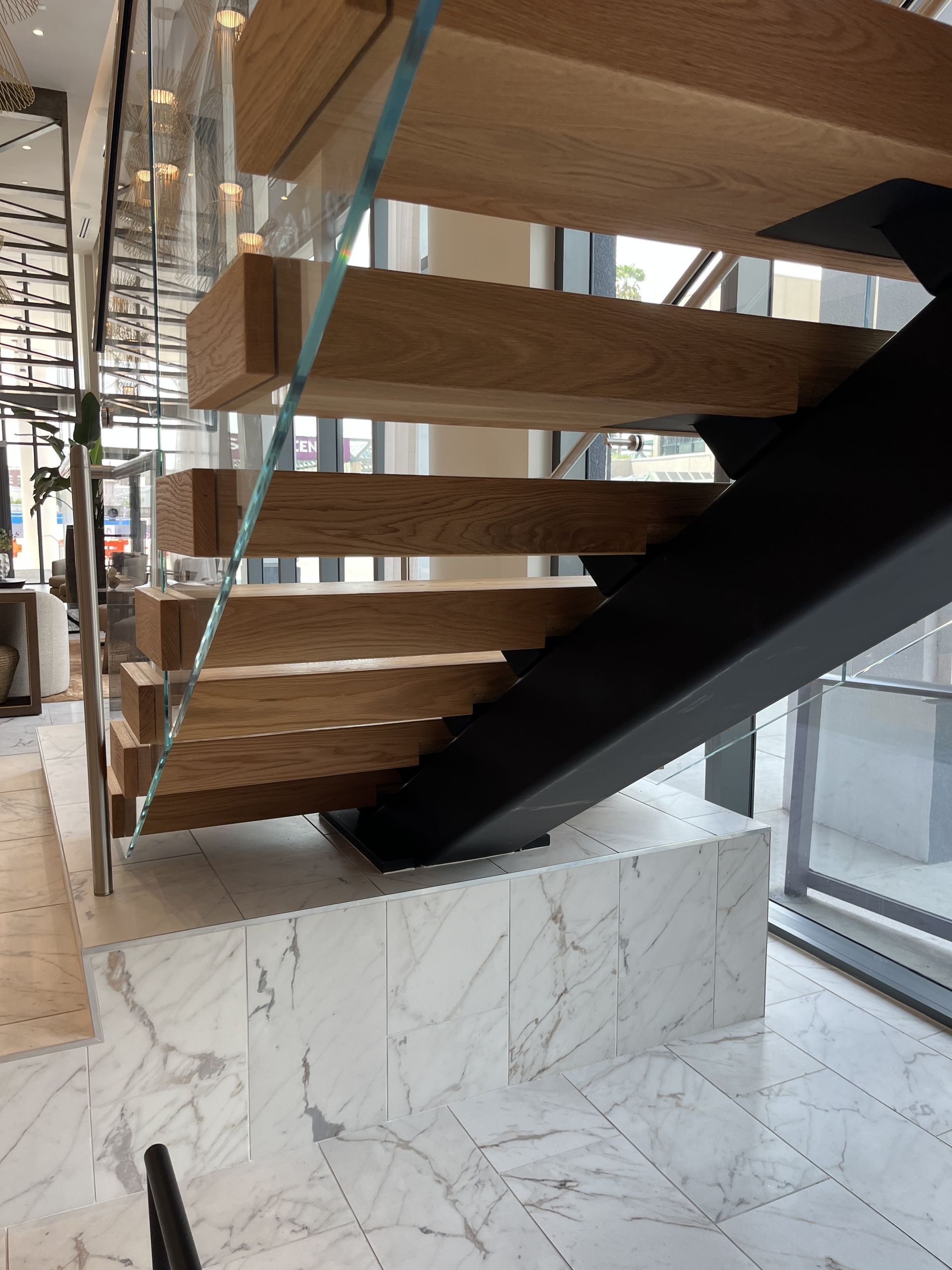 Modern staircase with wooden steps and glass rails
