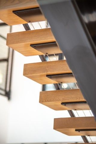 Indoor staircase with wood steps and metal accents