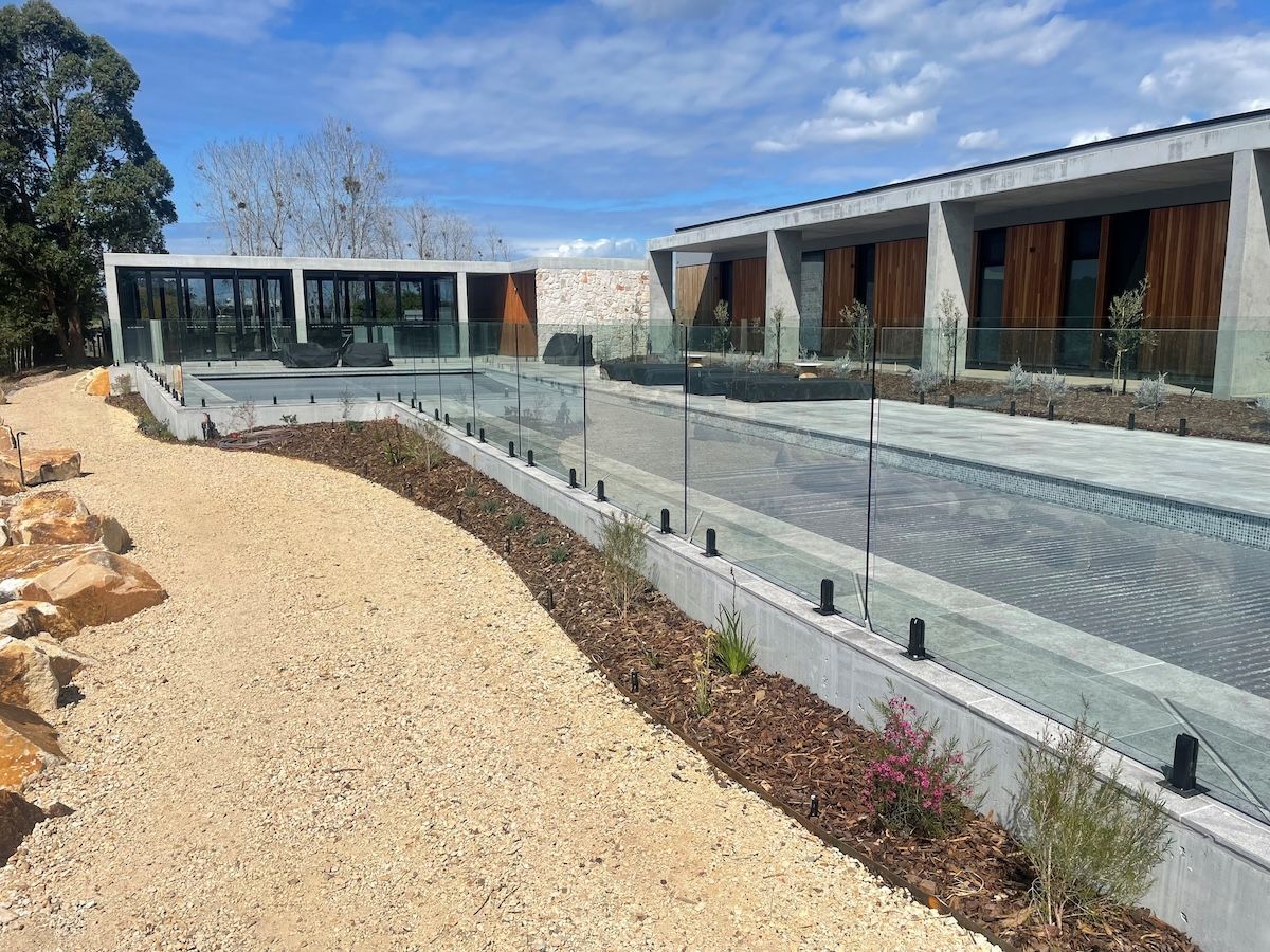 A large building with a swimming pool in front of it. — Topline Aluminium Forster Pty Ltd in Forster, NSW