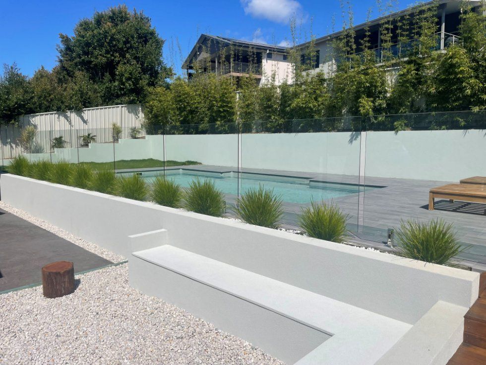 A Swimming Pool with A Fence Around It and A Bench in Front of It — Topline Aluminium Forster Pty Ltd in Forster, NSW