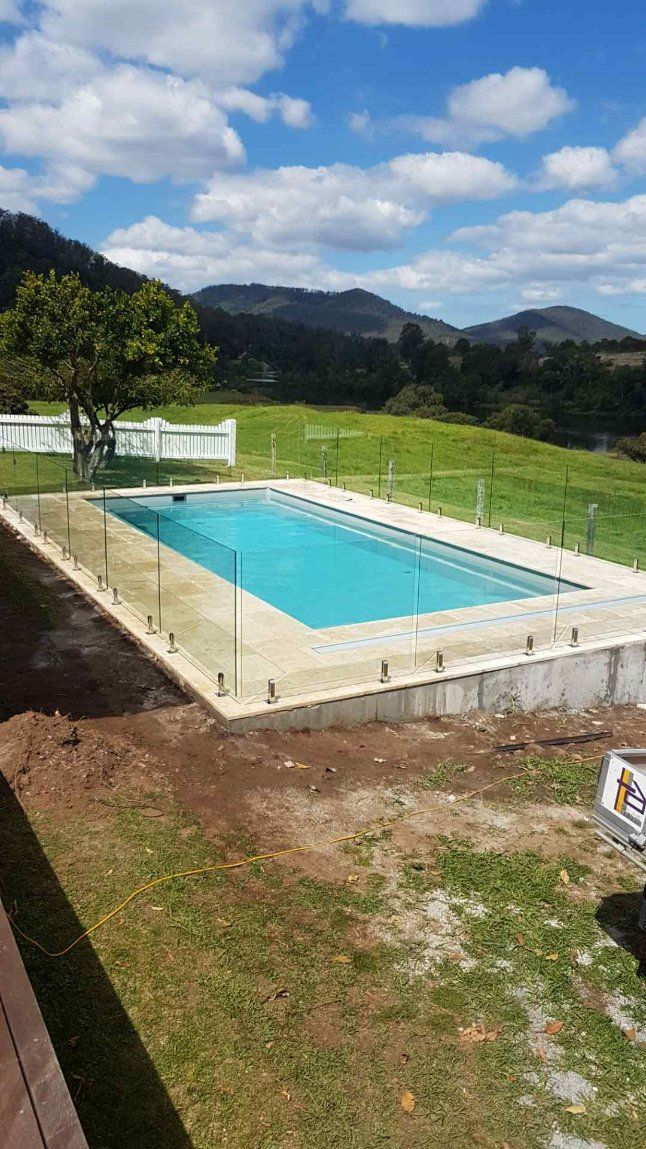 Swimming Pool Is Surrounded by A Fence — Topline Aluminium Forster Pty Ltd in Forster, NSW