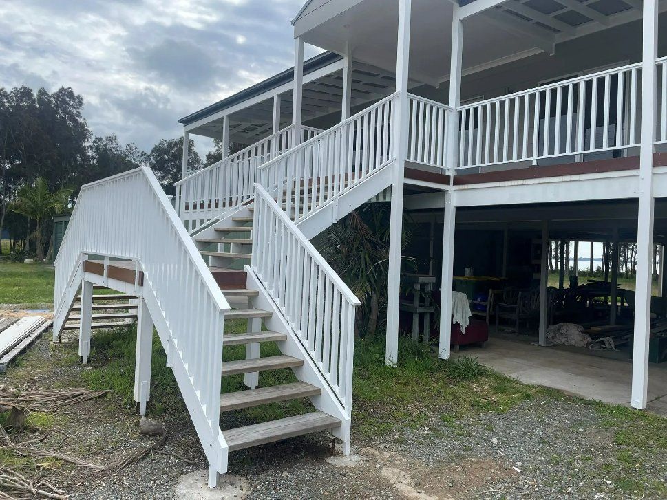 A White House with Stairs Leading up To the Second Floor — Topline Aluminium Forster Pty Ltd in Taree, NSW