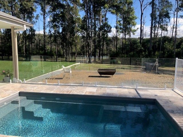 There Is a Swimming Pool in The Backyard of A House — Topline Aluminium Forster Pty Ltd in Smiths Lake, NSW