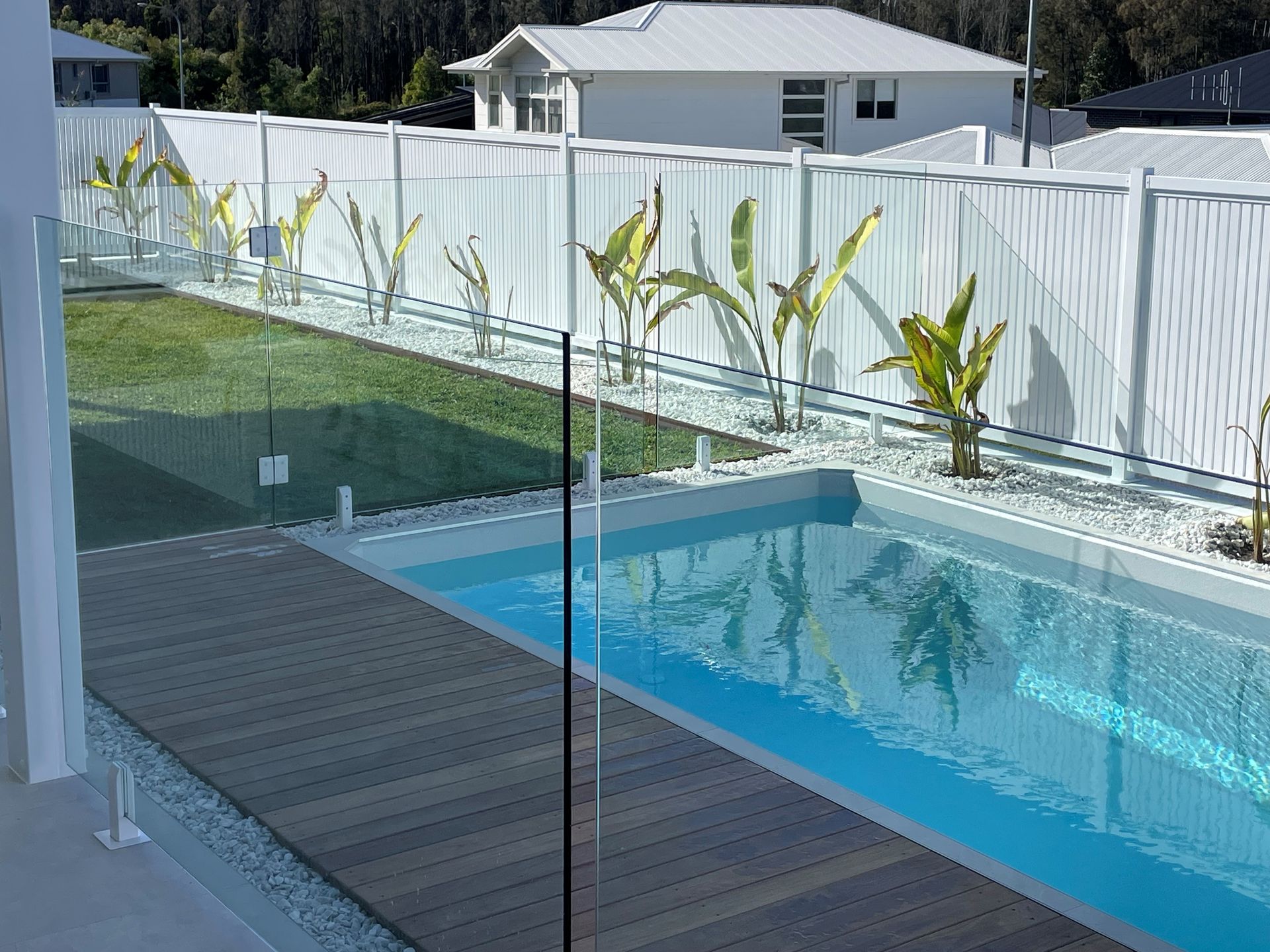 A Large Swimming Pool Is Surrounded by A Fence — Topline Aluminium Forster Pty Ltd in Forster, NSW
