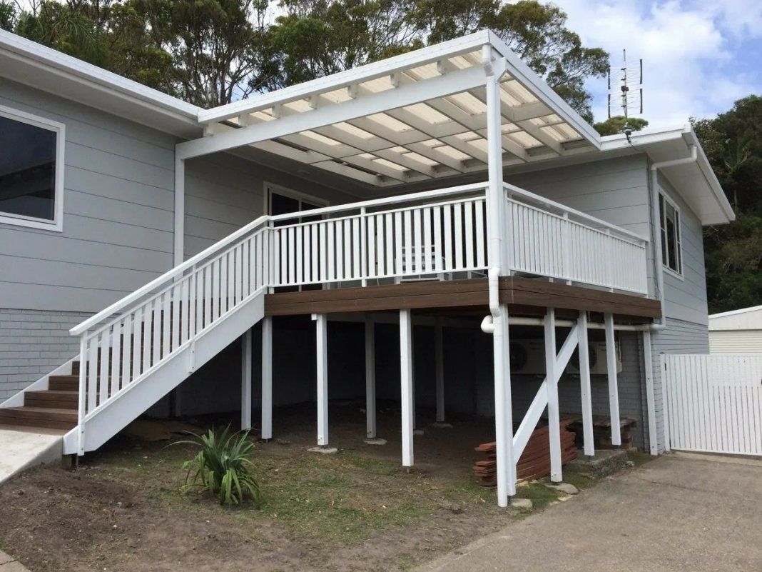 A White House with Stairs Leading up To a Deck — Topline Aluminium Forster Pty Ltd in Taree, NSW