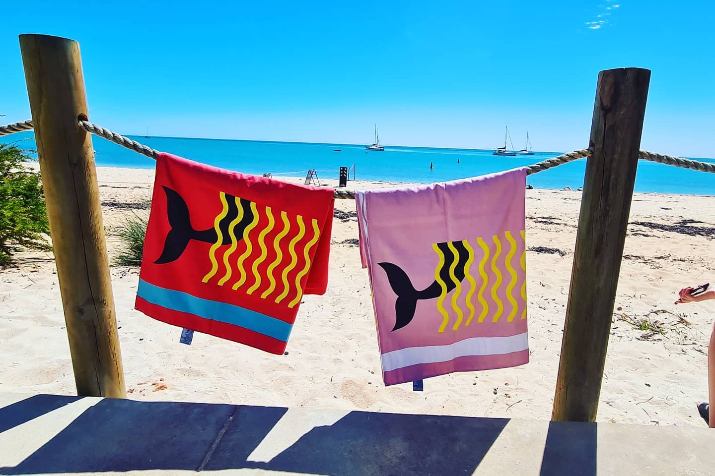 Belle & Phia towels  hung over drying rope