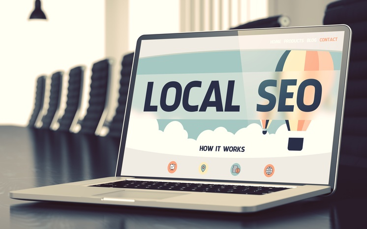 A laptop is open to a page that says local seo