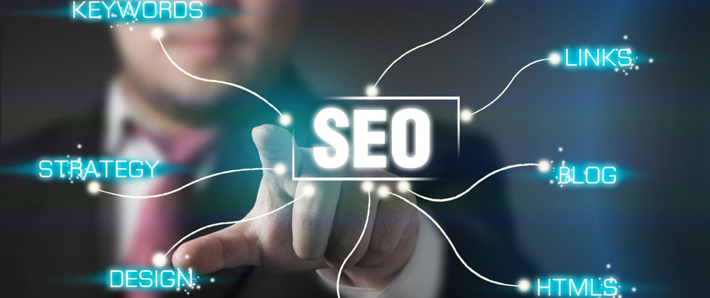 A man in a suit and tie is pointing at the word seo.