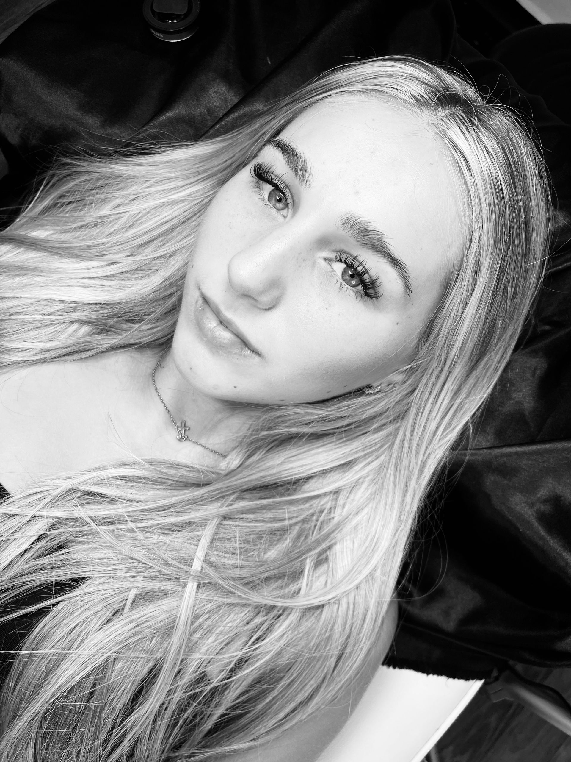 A happy client after lash extension treatment at Anya Ely