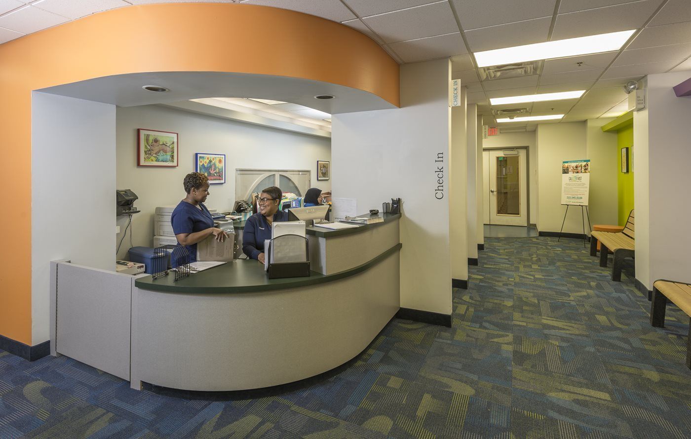 A couple of people sitting at a counter in a hospital