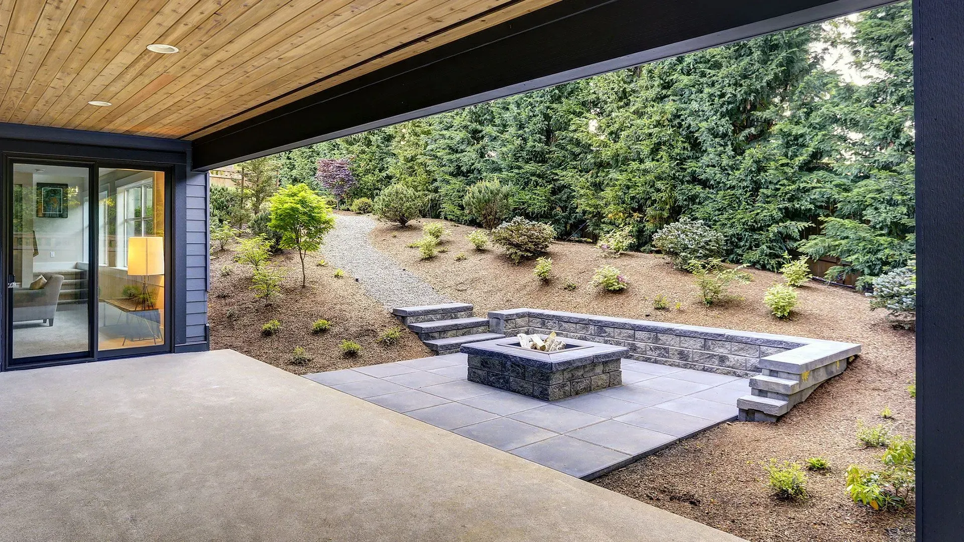 There is a fire pit in the backyard of a house.