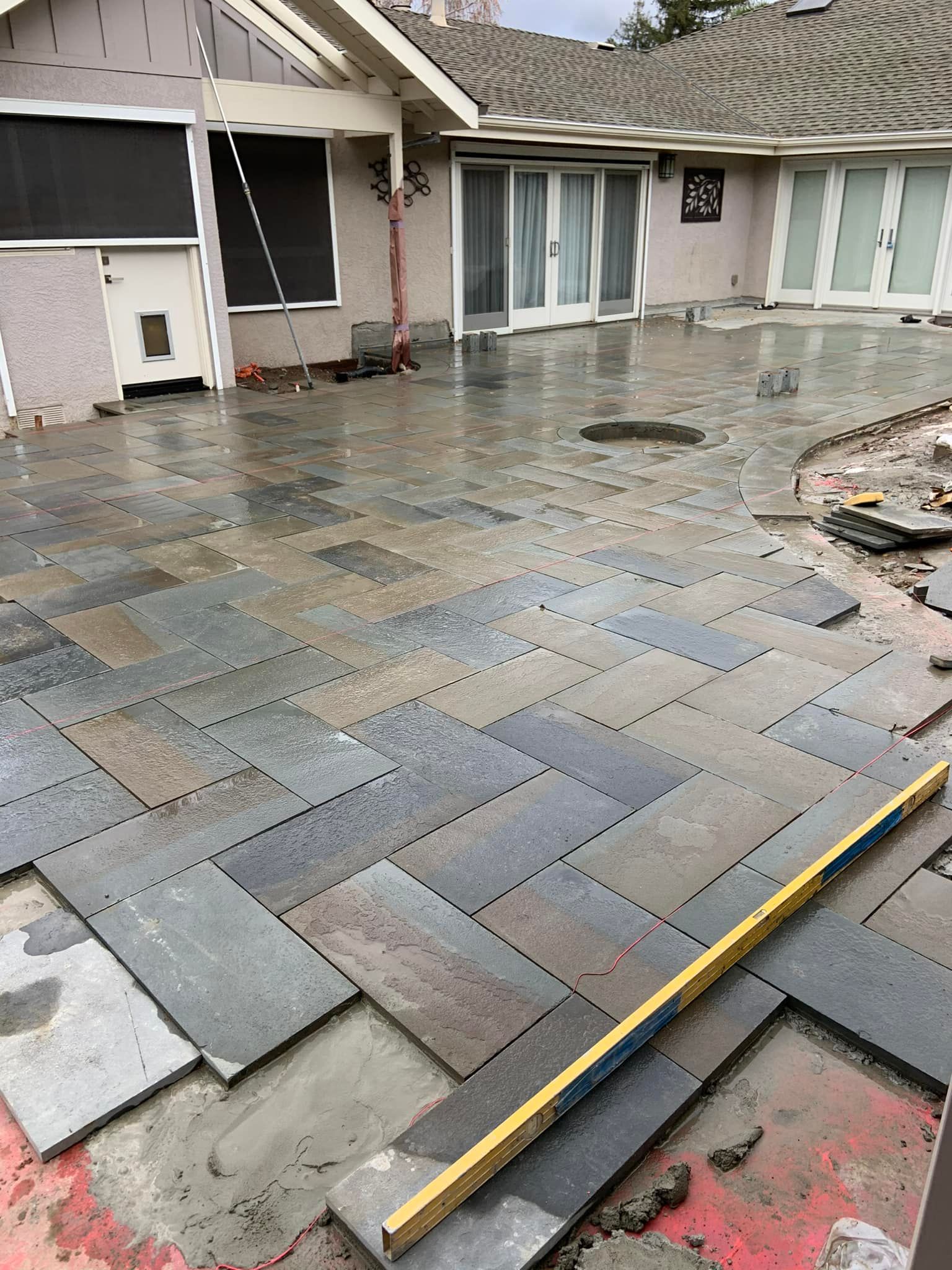 A patio is being built in front of a house.
