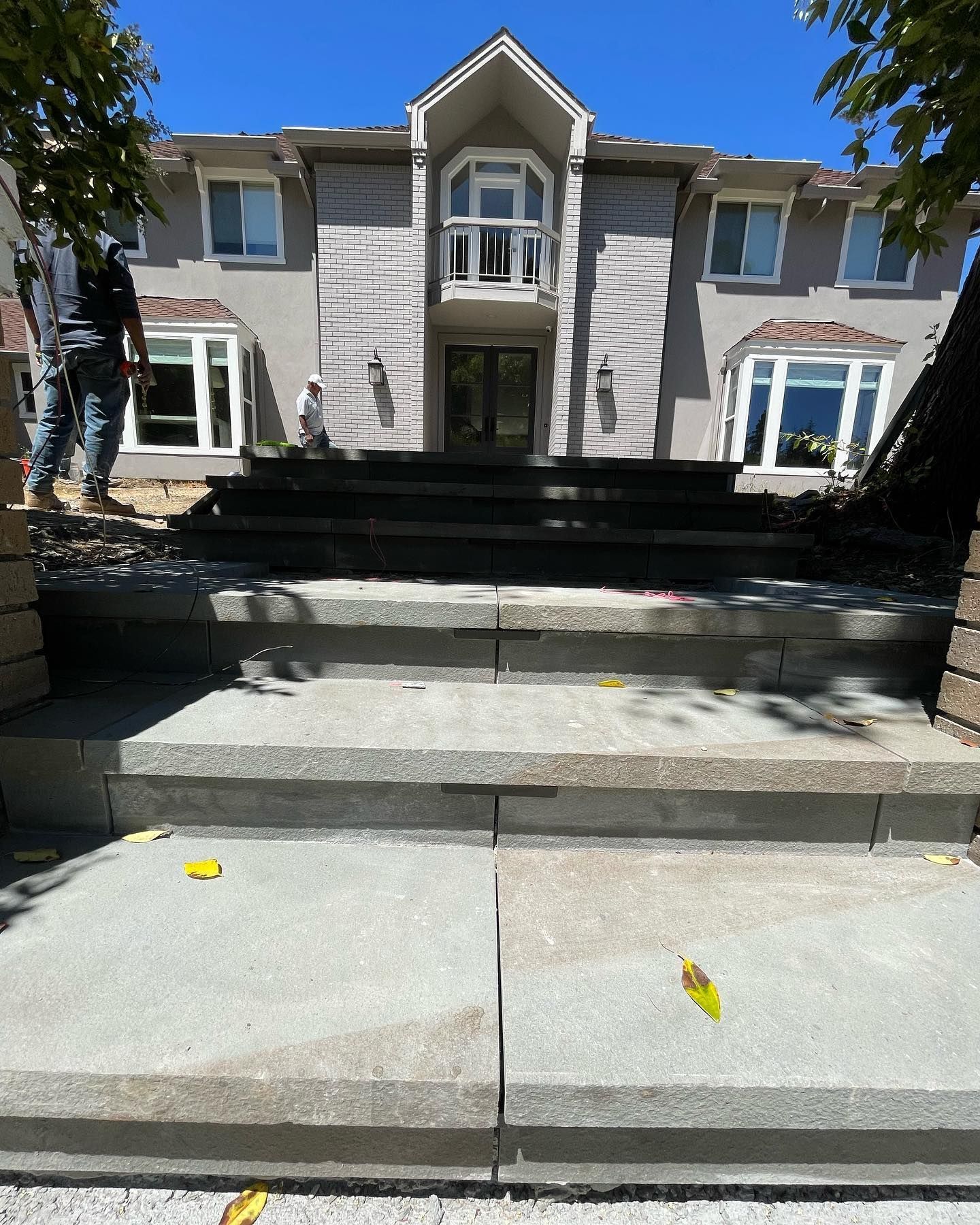 A large house with stairs leading up to it