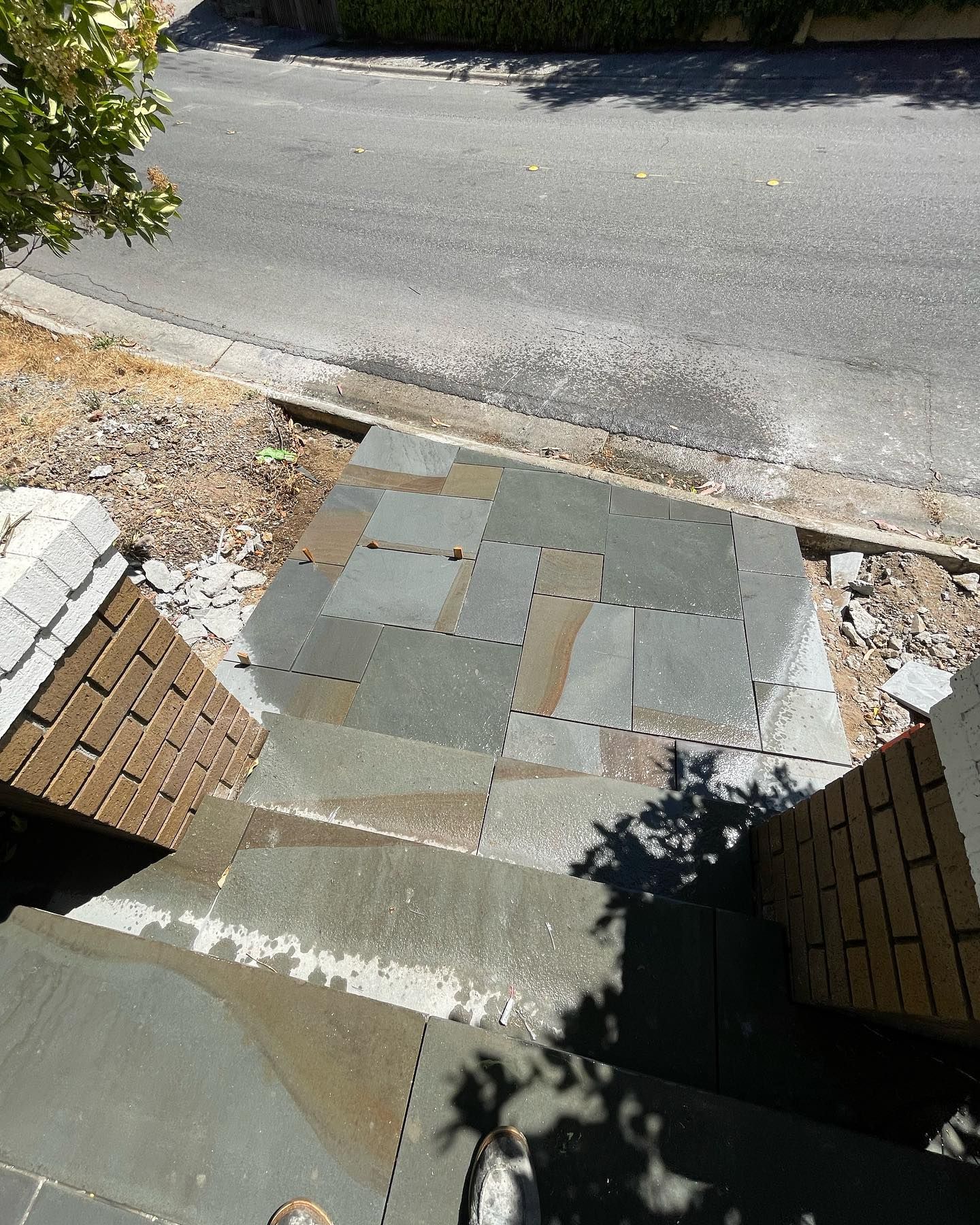 A person standing on a set of stairs next to a road