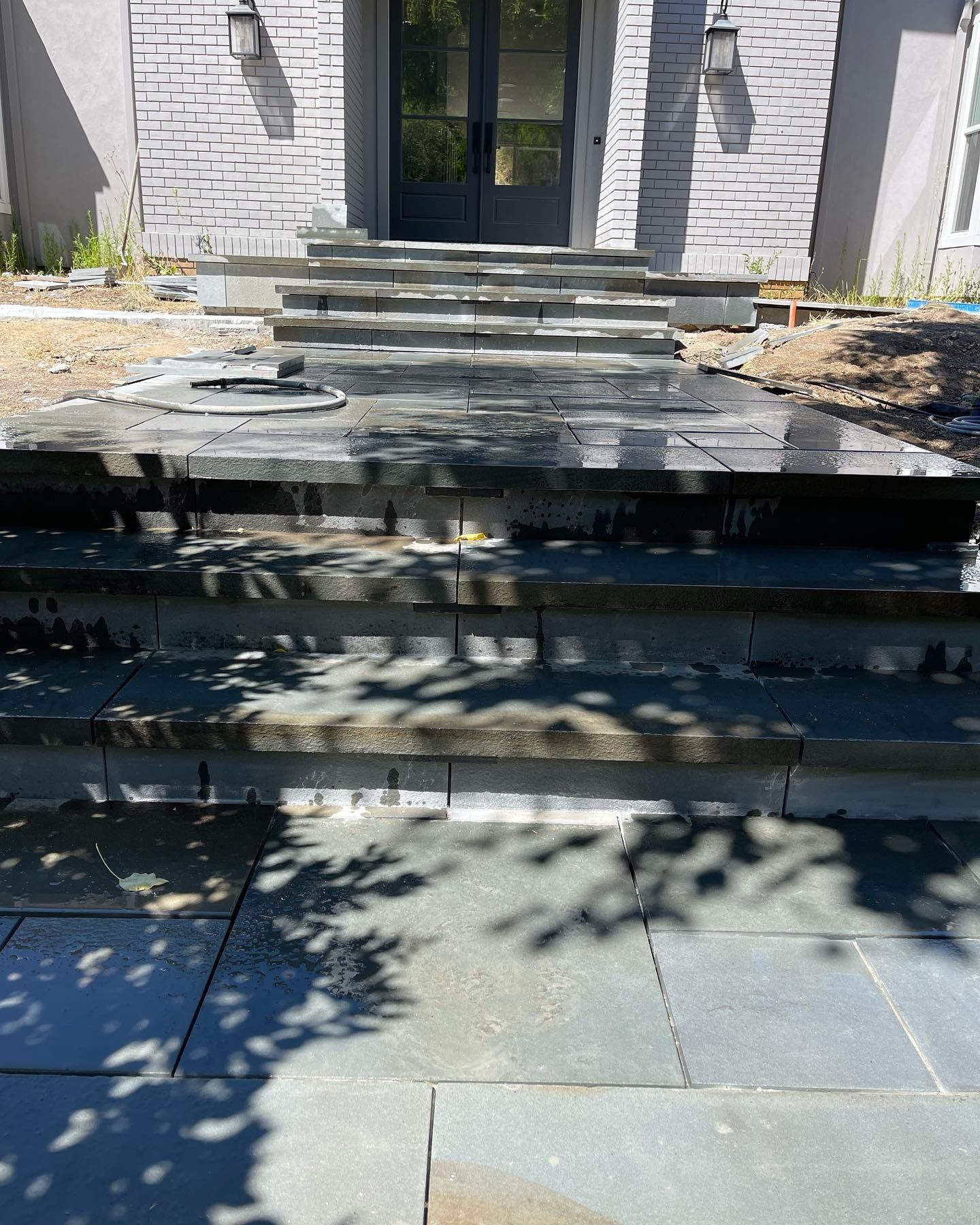 A set of stairs leading up to the front door of a house.