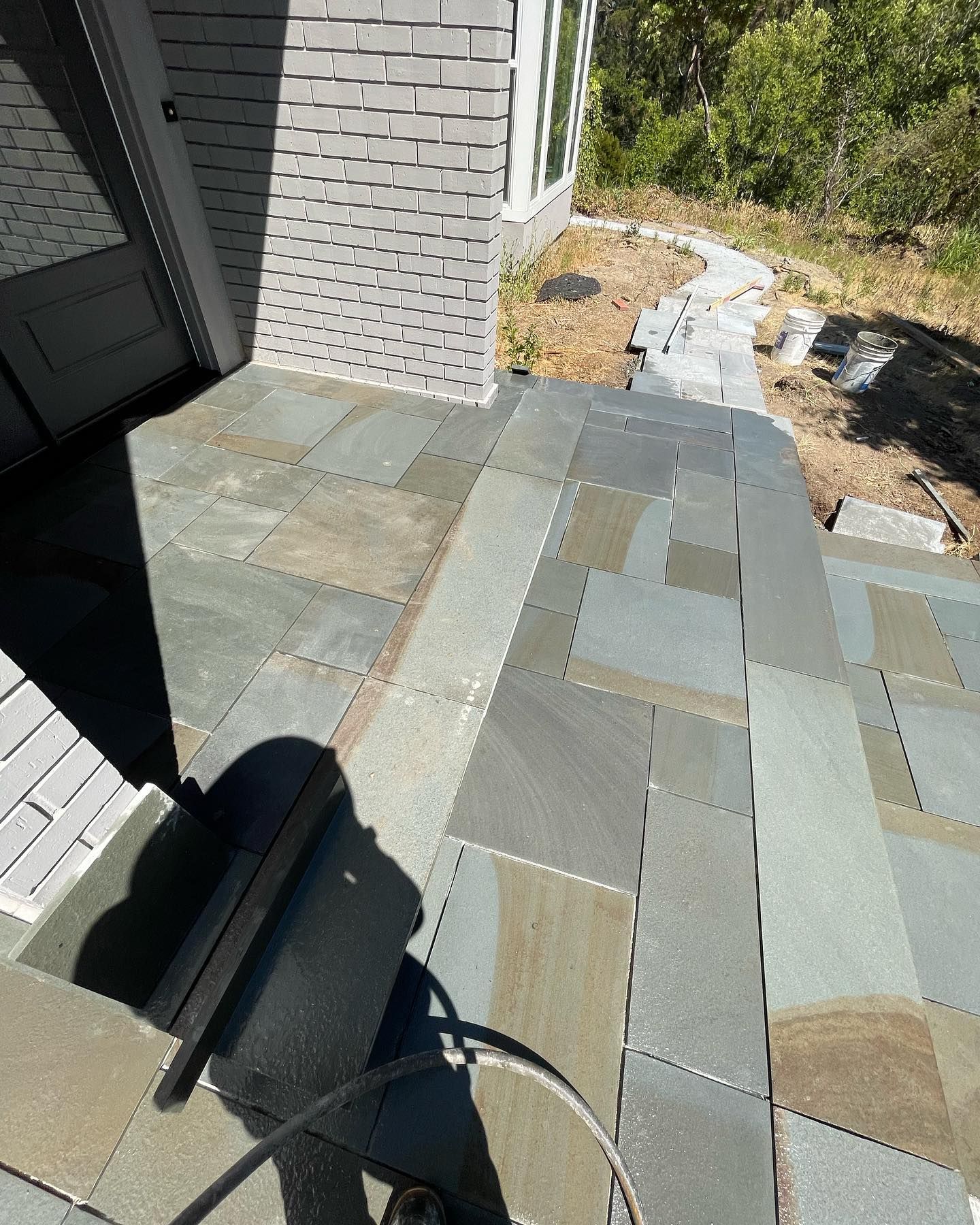 A camera is sitting on a patio next to a brick building