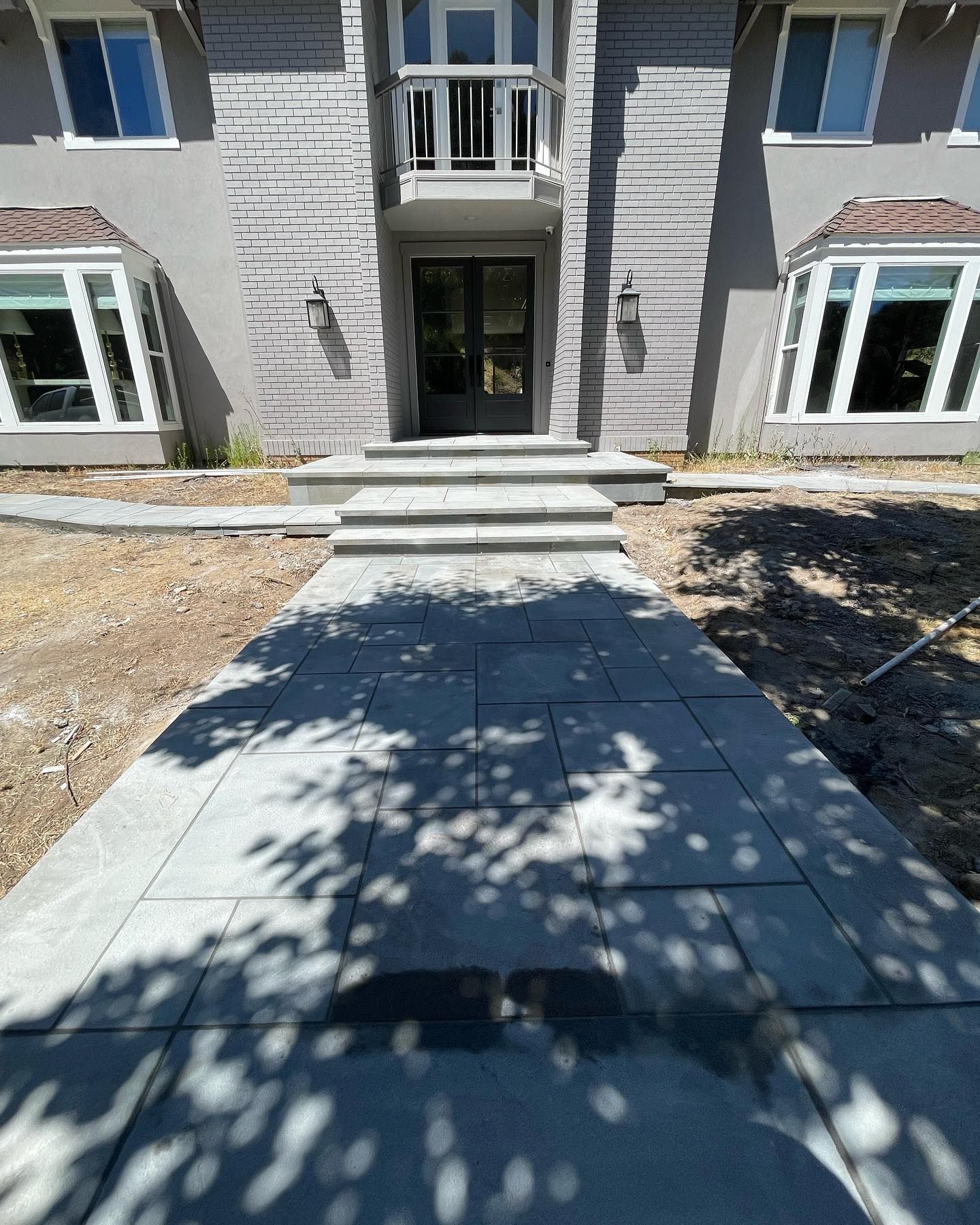 A brick house with a walkway leading to the front door