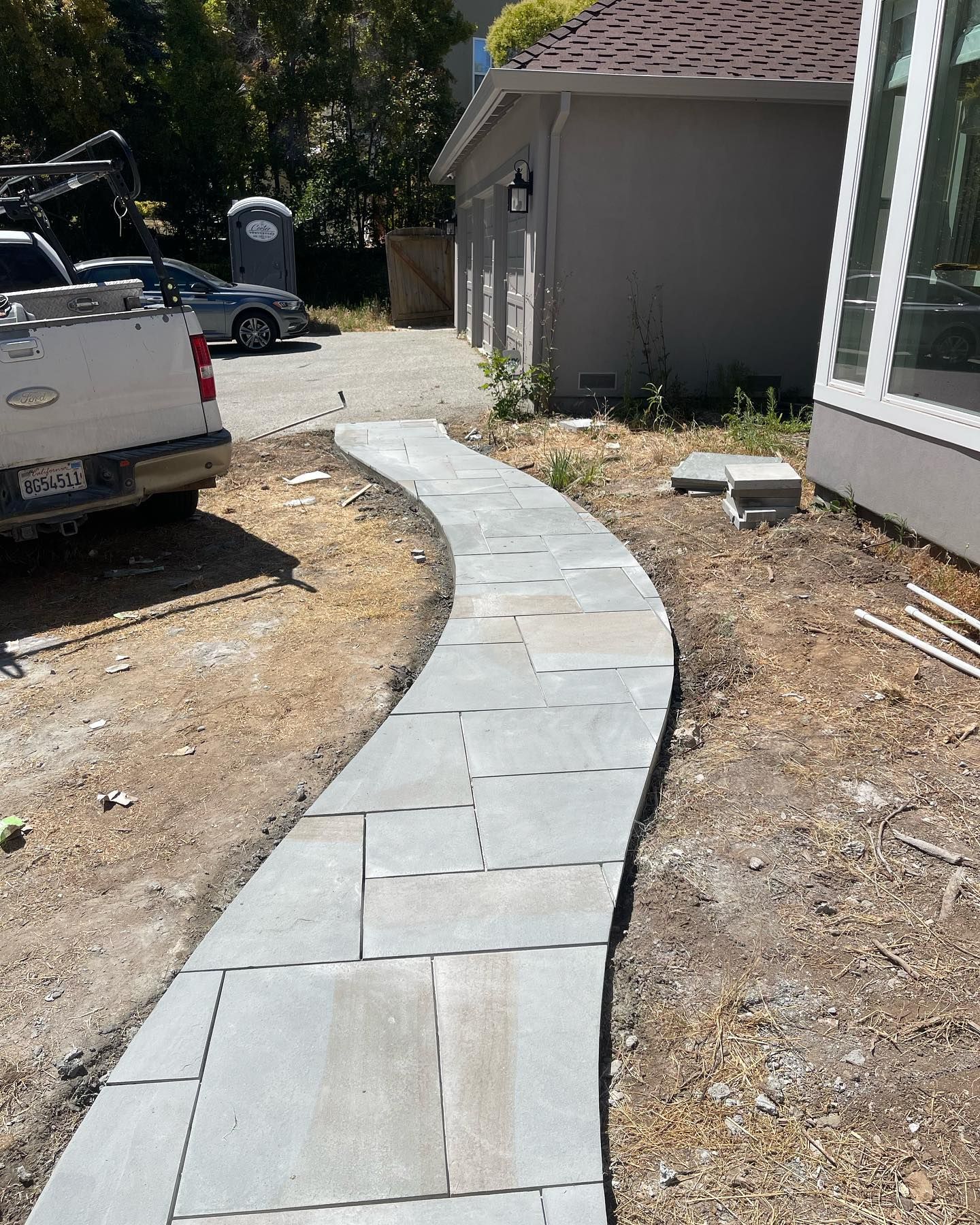 A walkway is being built in front of a house.