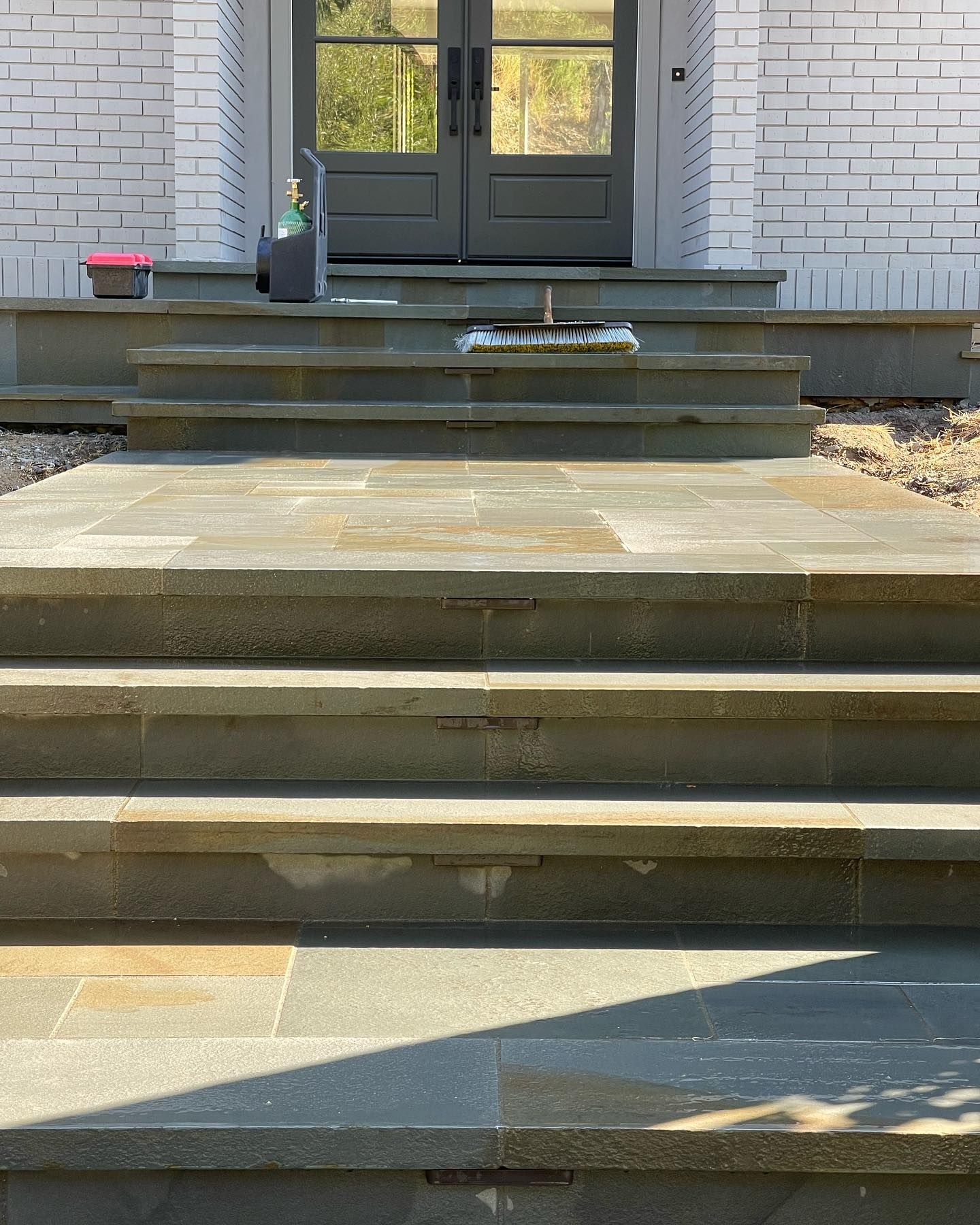 A set of stairs leading up to the front door of a house