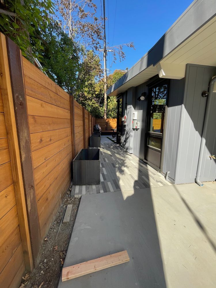 A wooden fence along the side of a building