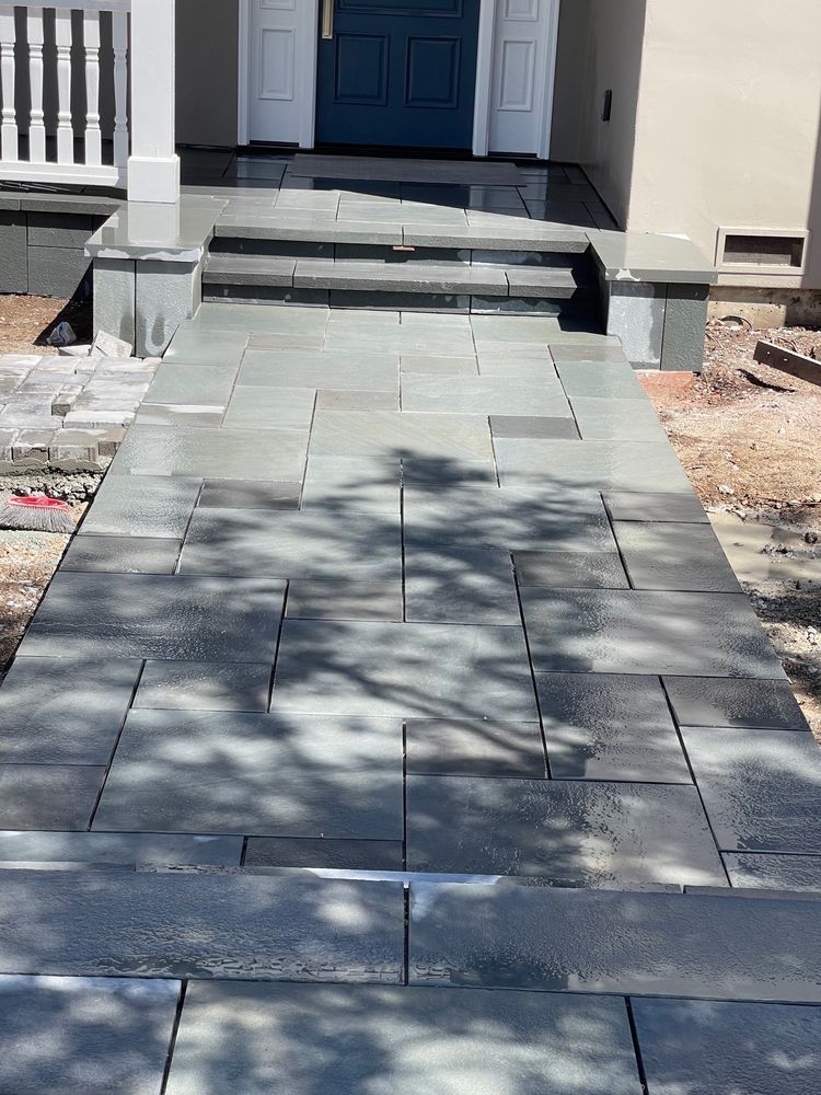 A stone walkway leading to the front door of a house.