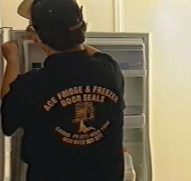 Repair man replacing door seals of refrigerator — Fridge and Freezer Door Repair and Seal Replacement in Cairns, QLD