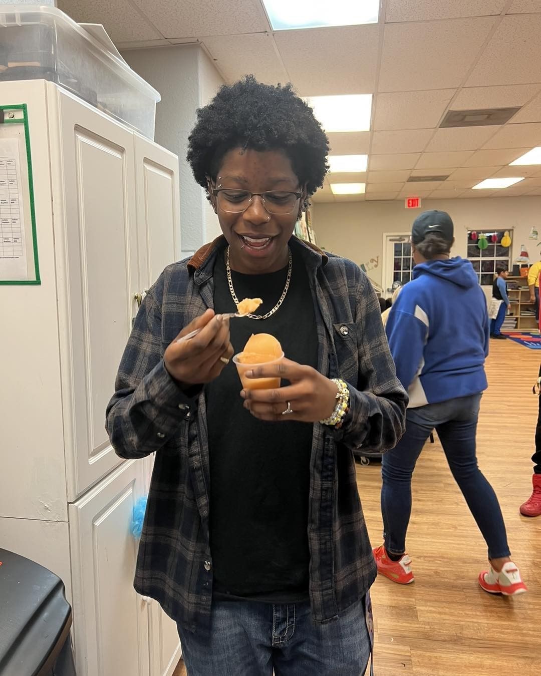 Person eating ice cream indoors.