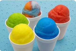 Five colorful snow cones in white cups on a blue background. Flavors include green, yellow, blue, red, and a swirl.