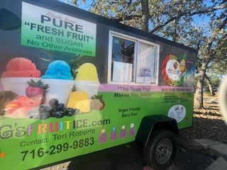 Green fruit ice cream truck with colorful shaved ice, text: G's Fruit Ice. Contact info on the side.