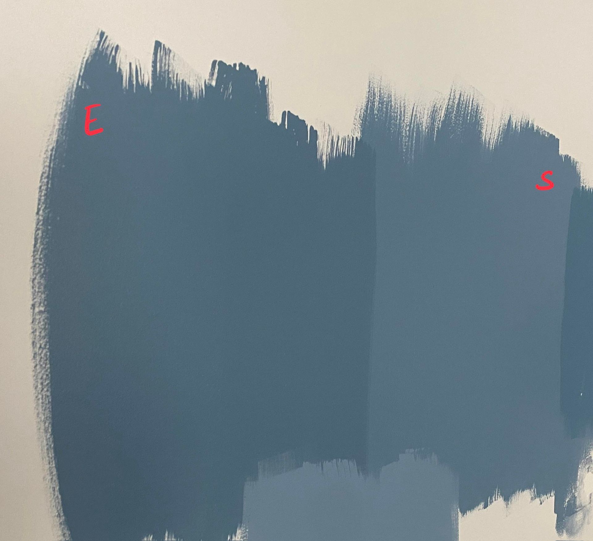 Paint swatches in shades of blue on a white wall.