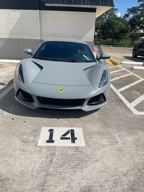 Gray Lotus sports car parked in spot marked