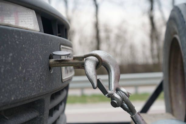 Tow hook attached to a car's bumper, ready for towing.
