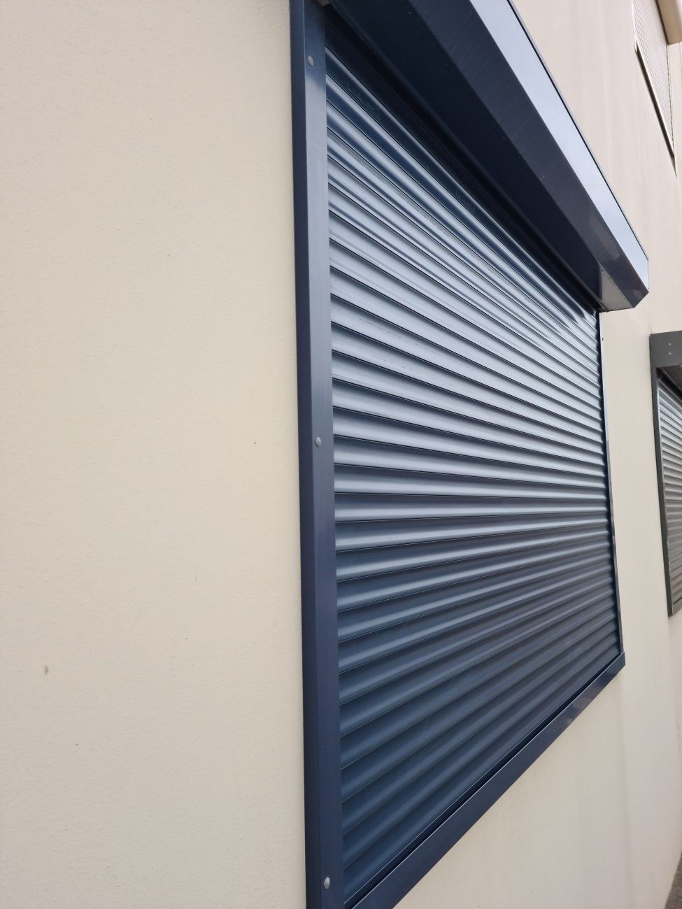 A Window With A Roller Shutter On It On The Side Of A Building — TT Shutters & Shading In Ballina, NSW
