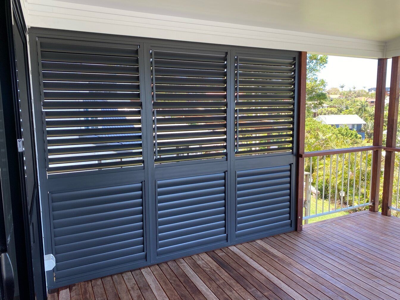 A Balcony With Shutters on It and a Wooden Floor — TT Shutters & Shading In Ballina, NSW