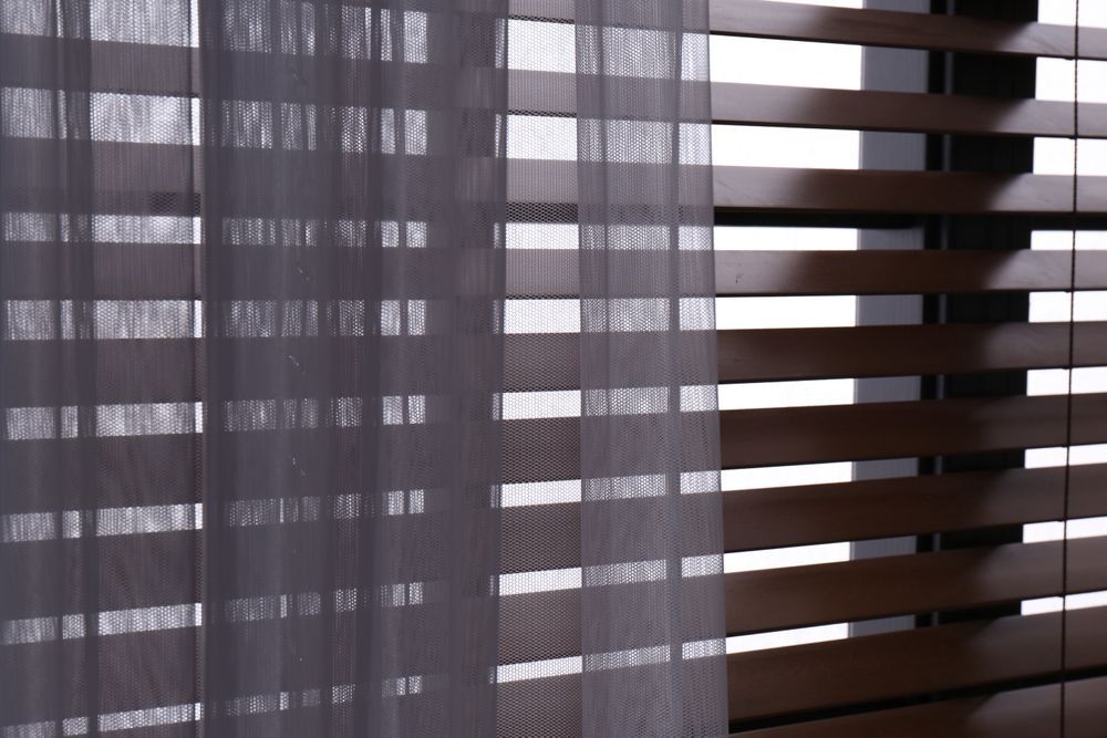 A Pair of Wooden Blinds on a Window — TT Shutters & Shading In Tweed Heads, NSW
