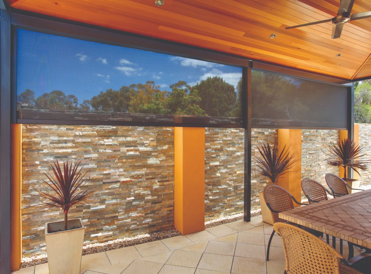 A Patio With A Table And Chairs And A Screen — TT Shutters & Shading In Ballina, NSW