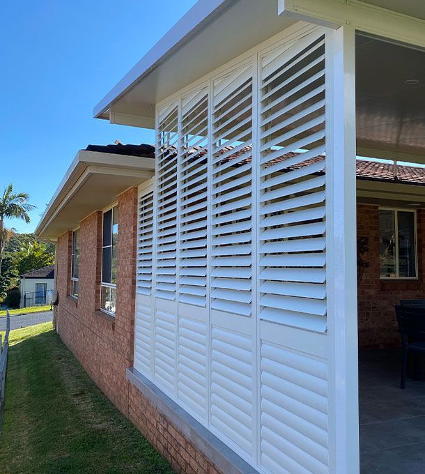 External aluminium shutters on brick house — TT Shutters & Shading In Ballina, NSW