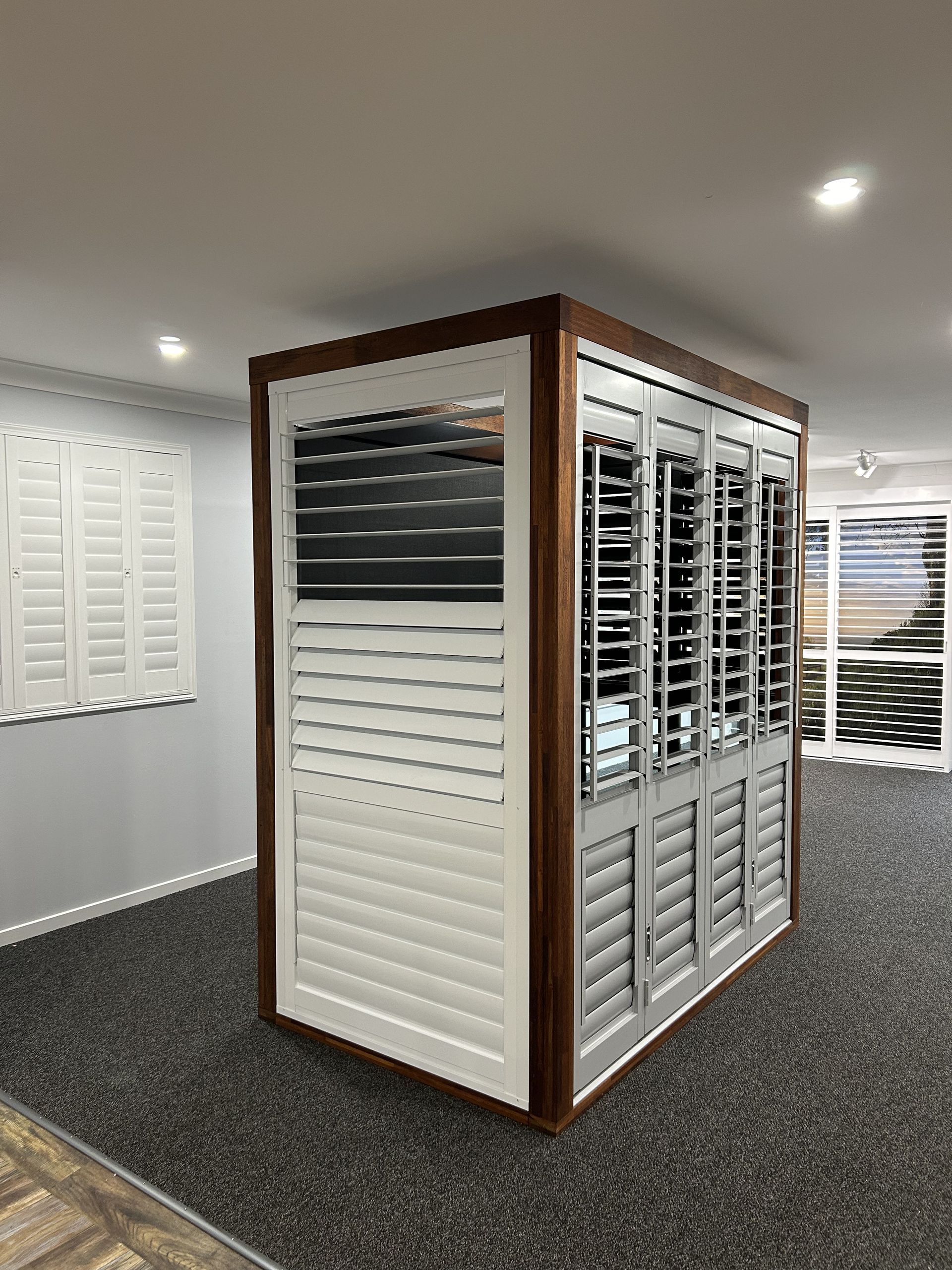 A Display of Shutters in a Room With a Carpeted Floor — TT Shutters & Shading In Ballina, NSW