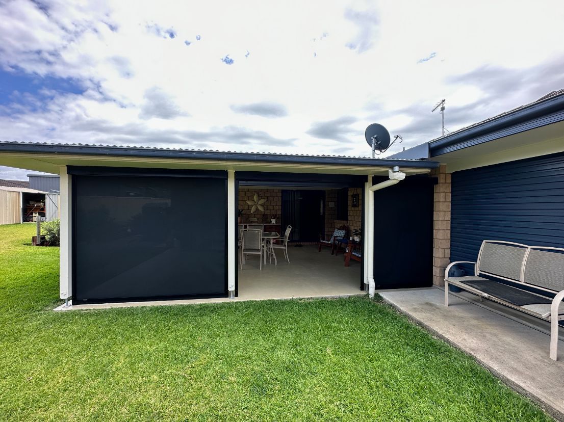 A House With A Patio Screened And A Bench In Front Of It — TT Shutters & Shading In Ballina, NSW