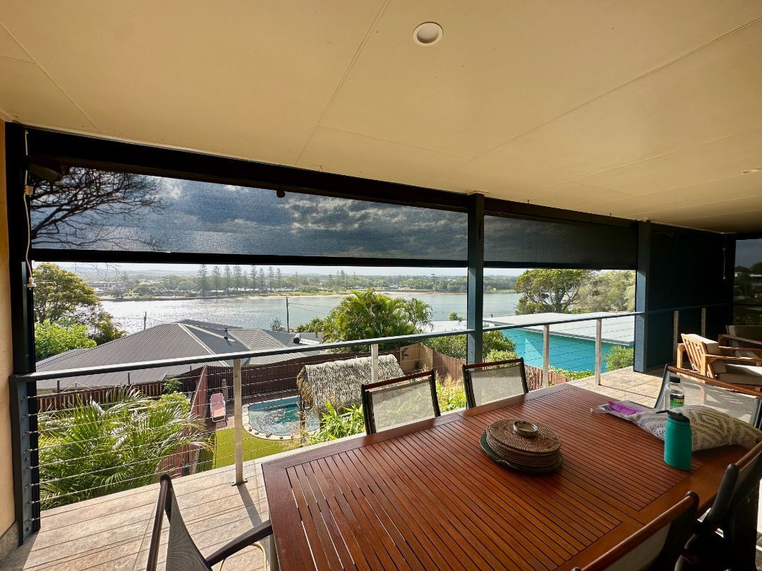 A Dining Table And Balcony With Screen — TT Shutters & Shading In Ballina, NSW