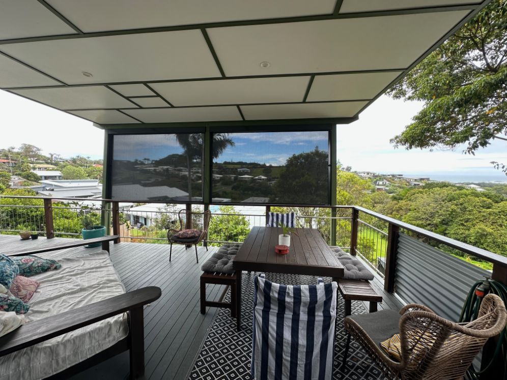 A Deck With A Zipscreen And Table And Chairs TT Shutters & Shading In Ballina, NSW