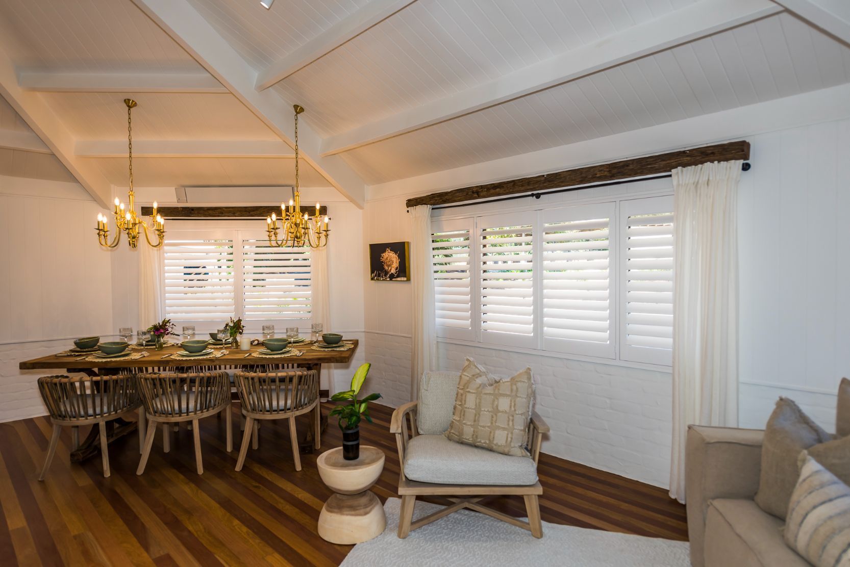 A Living Room With A Dining Table And Chairs And A Couch — TT Shutters & Shading In Ballina, NSW