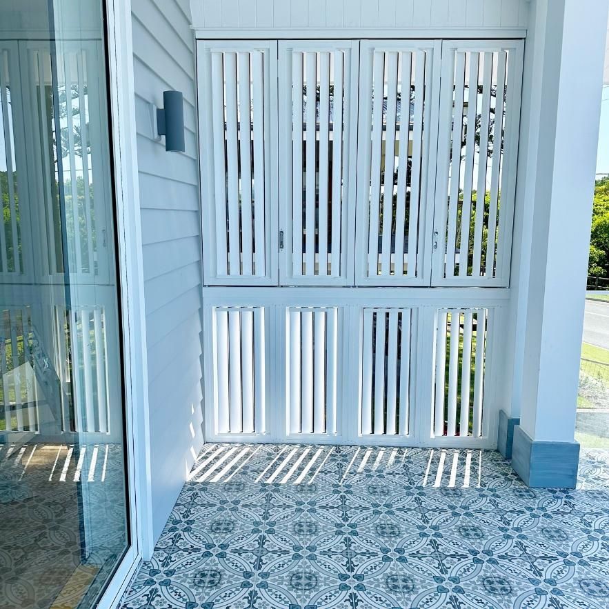 A Porch With a White Fence and a Sliding Glass Door — TT Shutters & Shading In Kingscliff, NSW