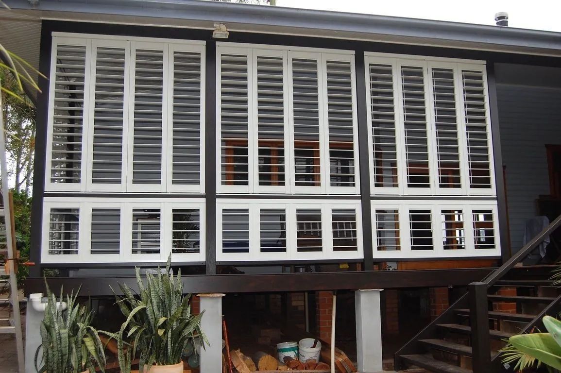 White Window Plantation Shutters In Ballina On Elevated Home Exterior