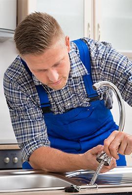 Plumber Fixing a Kitchen Sink — Drain Backups in Shelby Township MI