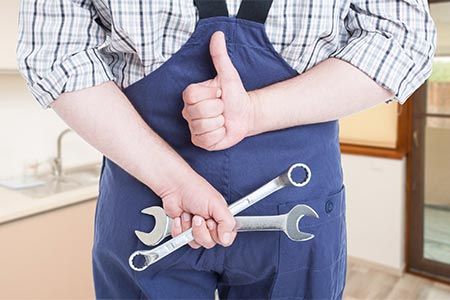 Plumber Holding Plumbing Tools — Drain Backups in Shelby Township MI