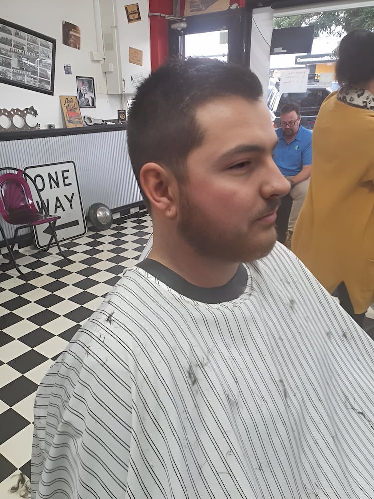 A Man Is Getting His Hair And Beard Cut At A Barber Shop — Get It Off Men's Barber Shop In Raymond Terrace, NSW