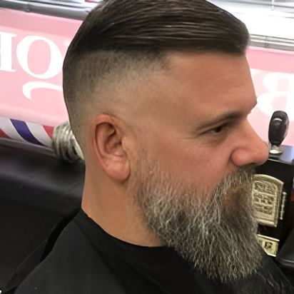 A Man With A Beard Is Getting His Hair Cut At A Barber Shop — Get It Off Men's Barber Shop In Raymond Terrace, NSW