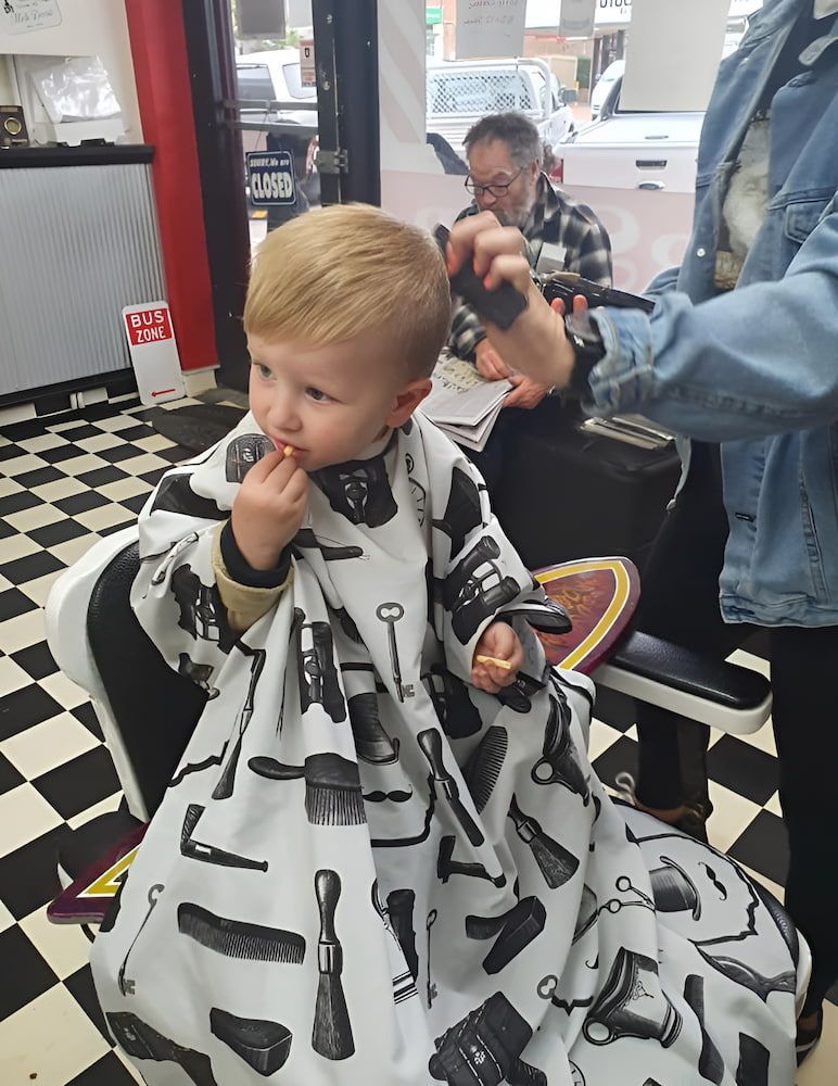 A Little Boy Is Getting His Hair Cut At A Barber Shop — Get It Off Men's Barber Shop In Raymond Terrace, NSW