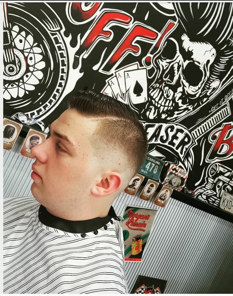 A Man Is Getting His Hair Cut At A Barber Shop — Get It Off Men's Barber Shop In Raymond Terrace, NSW